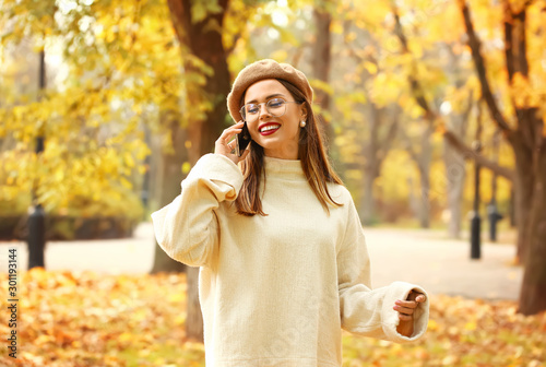 Stylish young woman talking...