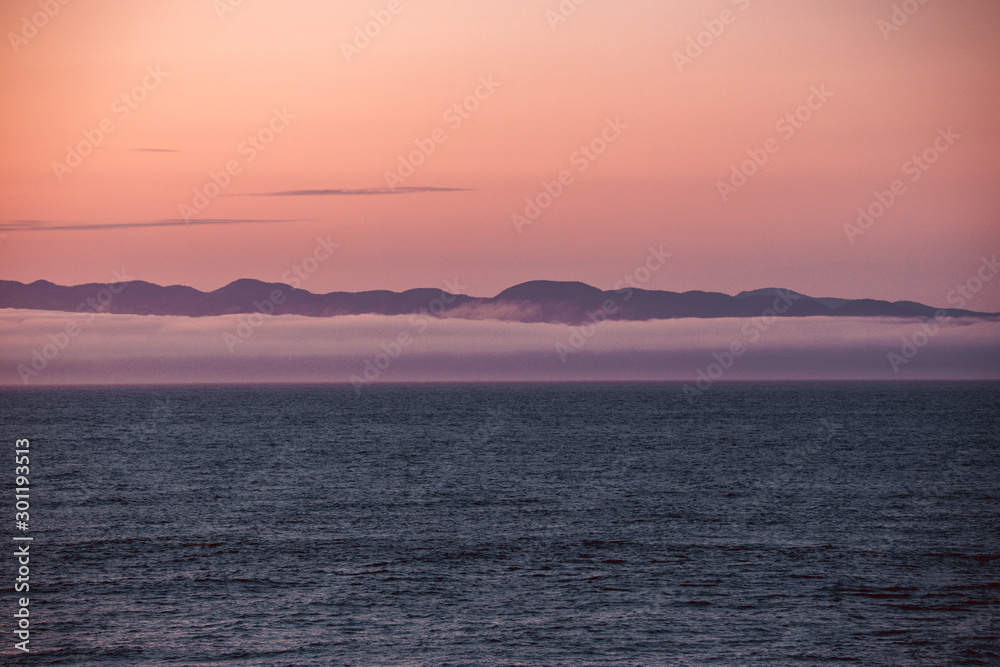 View of Vancouver Island from Port Angeles: the famous Washington State mist on the sea, with mountains in the background. Soft, romantic scenery.