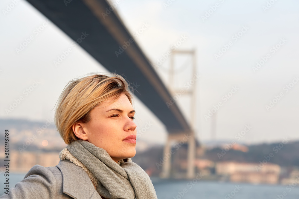 Portrait of a young woman under the Bosporus bridge. Portrait of a young woman under the Bosporus bridge.
