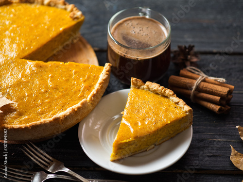 Traditional American thanksgiving pumpkin pie and coffee mug photo