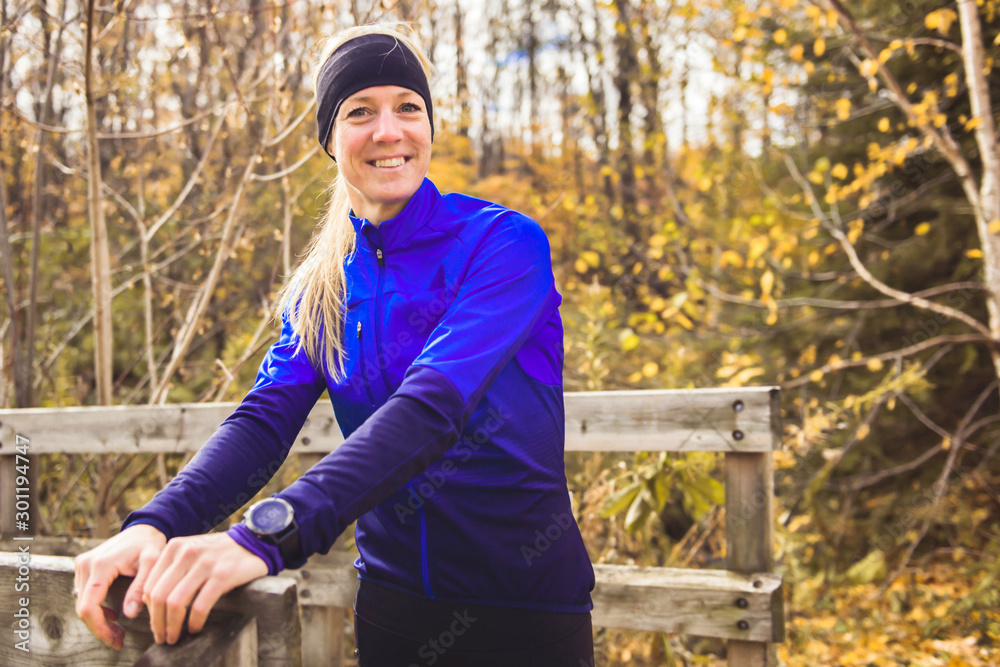 A stretching woman jogging in autumn nature A stretching woman jogging in autumn nature