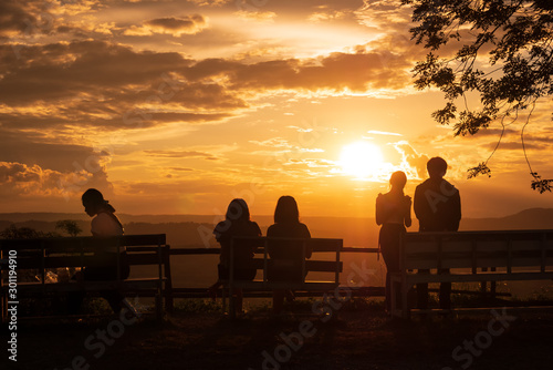 The silhouette of the tourist standing on the sunset