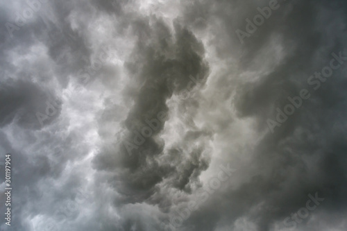 Dark sky and dramatic black cloud before rain.A tropical cyclone is a rapidly rotating storm system characterized by a low-pressure center, a closed low-level atmospheric circulation, strong 