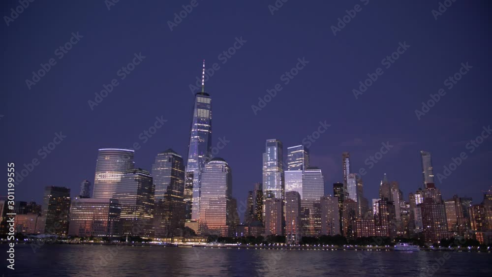 wide handheld shot of New York skyline at sunset from a boat on hudson river wide handheld shot of New York skyline at sunset from a boat on hudson river