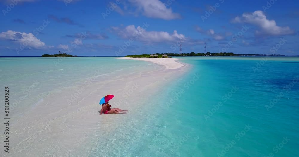 tourists on vacation sitting on a private tanning beach in Bali tourists on vacation sitting on a private tanning beach in Bali