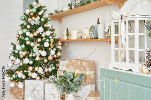 Christmas decor in kitchen. Christmas tableware. Christmas cooking utensils. Bright interior of New Year's cuisine. New Year card template. White Mint Colors Kitchen. Christmas tree in the kitchen.
