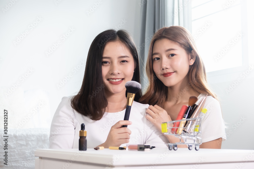Asian woman shopping online for new dress. All content is made up.Model shopping cart, basket.Online shopping concept Asian woman shopping online for new dress. All content is made up.Model shopping cart, basket.Online shopping concept