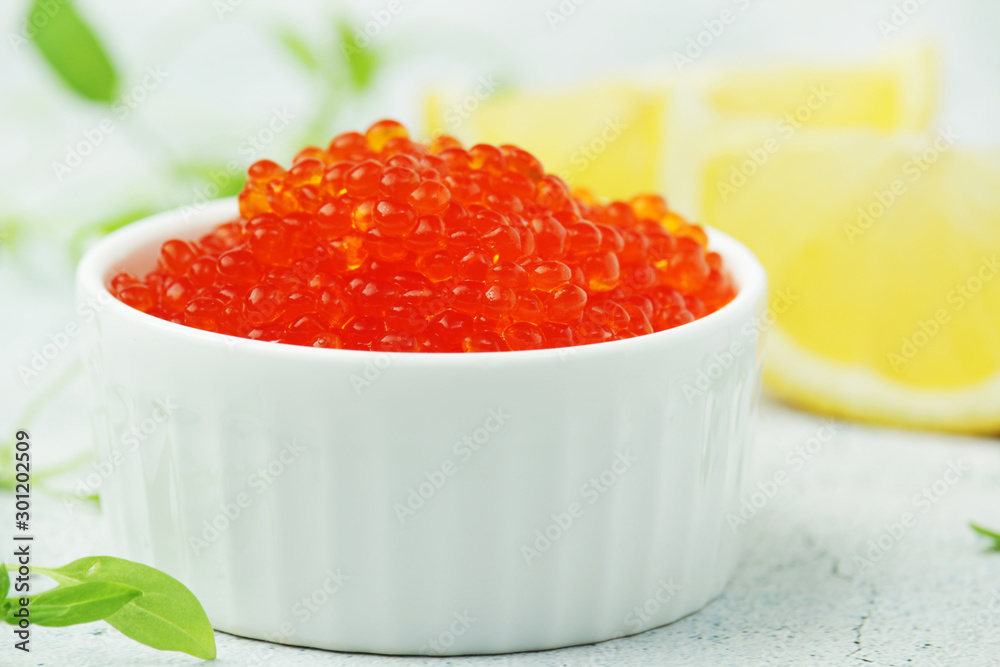 A small ceramic bowl with red caviar A small ceramic bowl with red caviar