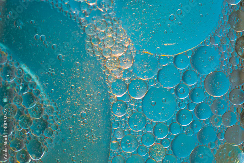 Air bubbles in the water background.Abstract oxygen bubbles in the sea.Circle foamy air in the ocean.Water bubbles isolate on blue background.