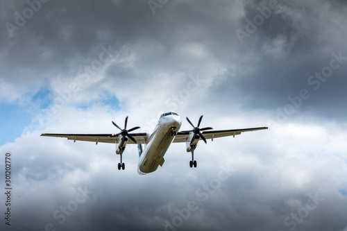 Propeller airplane flying in the cloudy skies © Jean-Claude Caprara