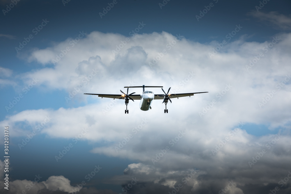 Propeller airplane flying in the cloudy skies Propeller airplane flying in the cloudy skies