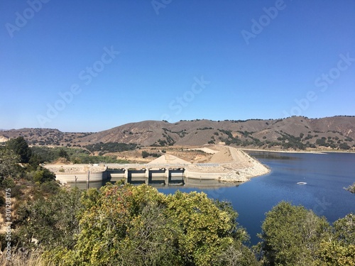 View of the dam across man-made lake at Cachuma Lake Recreation Area, Santa Barbara in Southern California.  photo