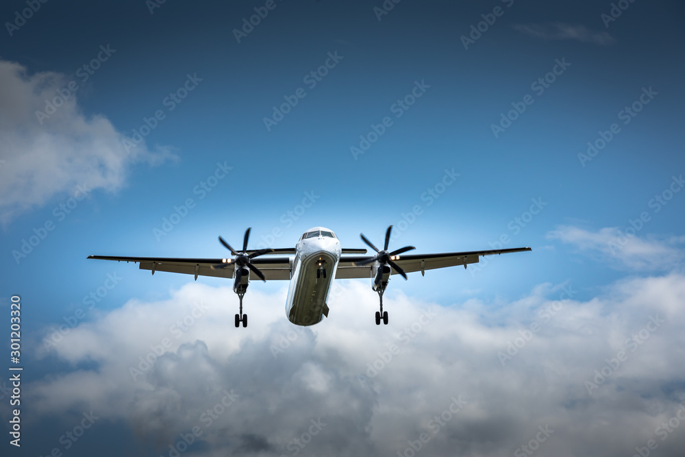 Propeller airplane flying in the cloudy skies Propeller airplane flying in the cloudy skies