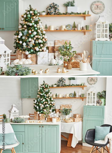 Interior light kitchen with christmas decor and tree. Collage photos of  turquoise-colored kitchen in classic style. Christmas in the kitchen. Bright kitchen in mint and white shades with Christmas.