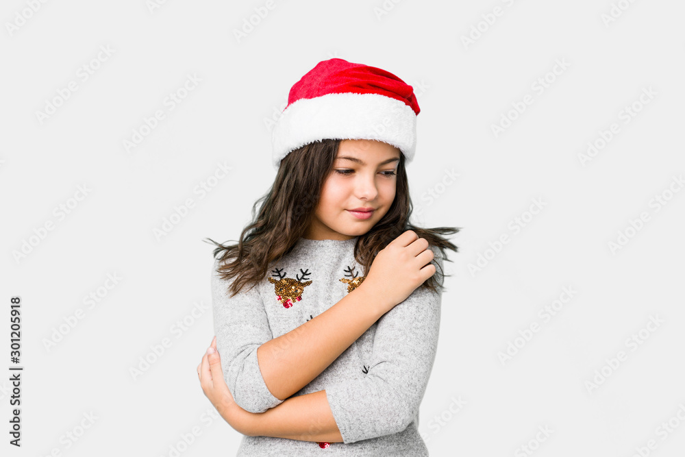 Little girl celebrating christmas day hugs, smiling carefree and happy. Little girl celebrating christmas day hugs, smiling carefree and happy.