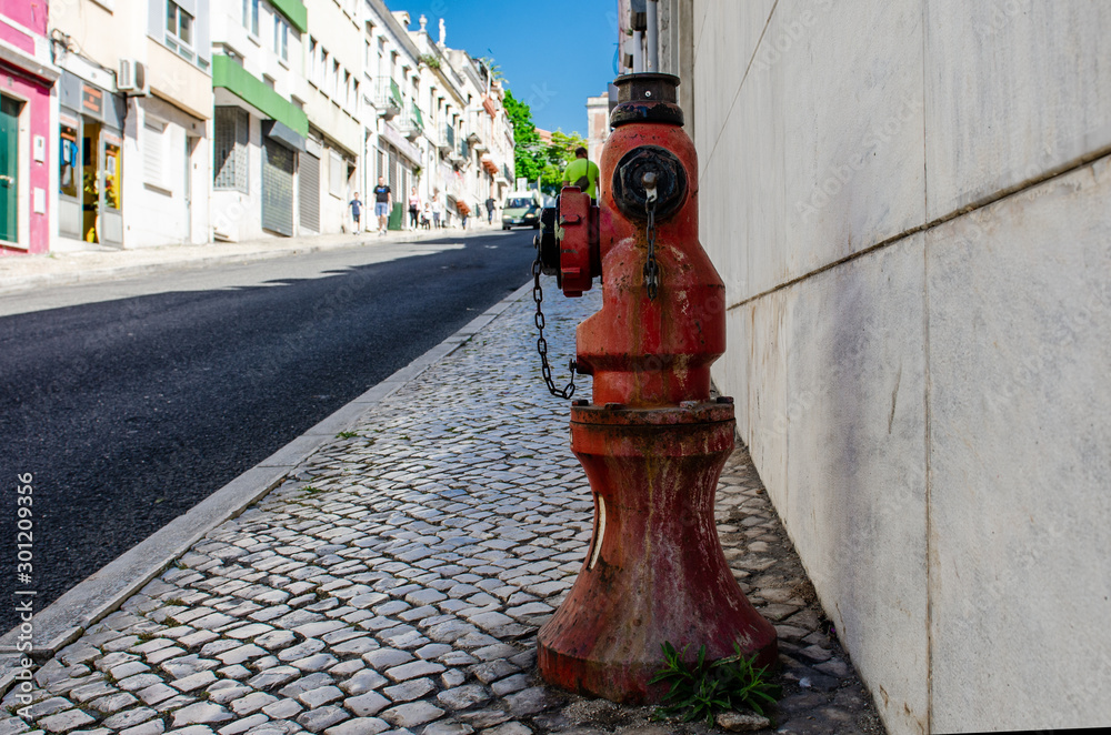 red water column on a city street red water column on a city street