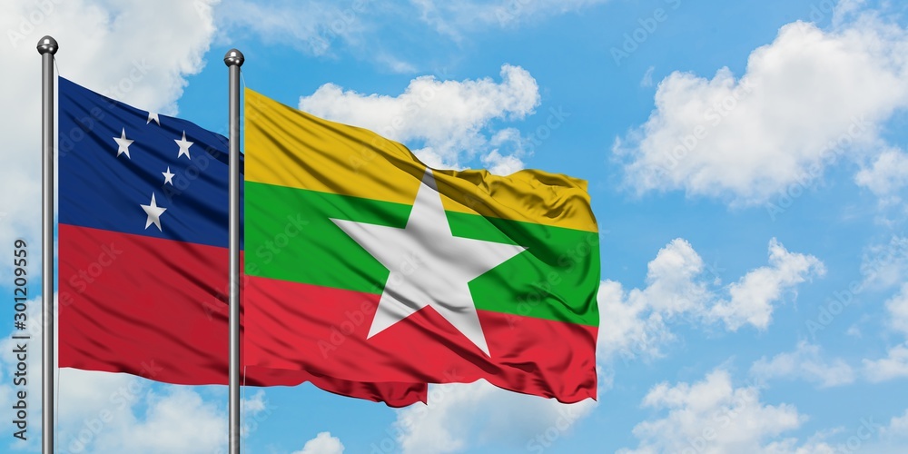 Samoa and Myanmar flag waving in the wind against white cloudy blue sky together. Diplomacy concept, international relations. Samoa and Myanmar flag waving in the wind against white cloudy blue sky together. Diplomacy concept, international relations.