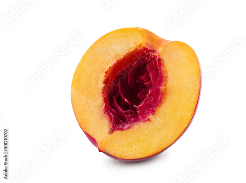 Unpitted, smooth-skinned half of nectarine fruit isolated on white background with copy space for text or images. Close-up shot.