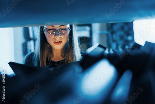 Power of imagination. Light goes from the ook. Female student is in library that full of books. Conception of education photo