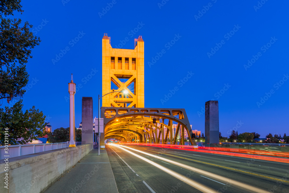 Tower Bridge in Sacramento, California, USA at dusk. It is a vertical lift bridge which crosses the Sacramento River. The bridge opened in 1935.