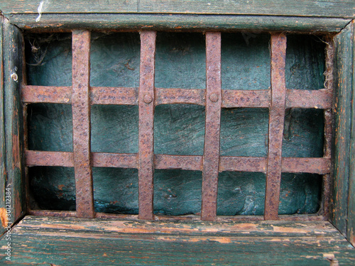Old grill on a wooden door