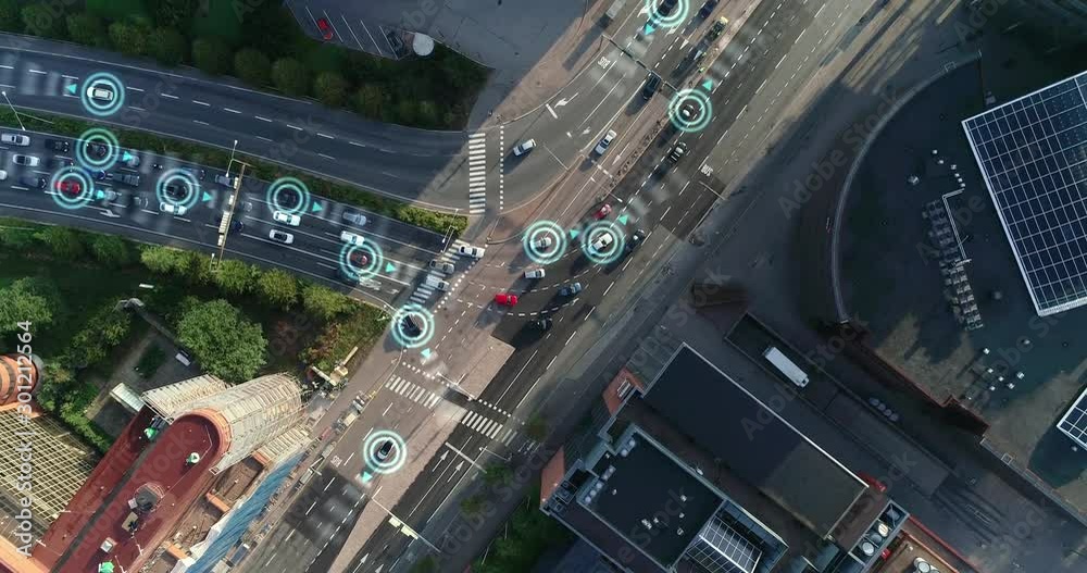 Top down aerial drone. Autonomous self driving cars moving through city. Traffic lights and rush hour. Artificial intelligence in automotive industry. Sunny day at Helsinki Finland.