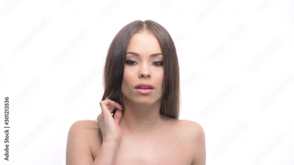 Young brunette woman beauty looking down and raising head looking up at camera with smile isolated on white background. Young brunette woman beauty looking down and raising head looking up at camera with smile isolated on white background.
