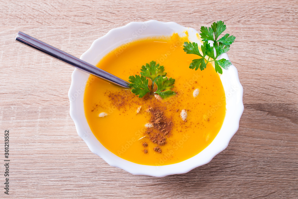 cream or pure pumpkin on plate with wooden background cream or pure pumpkin on plate with wooden background