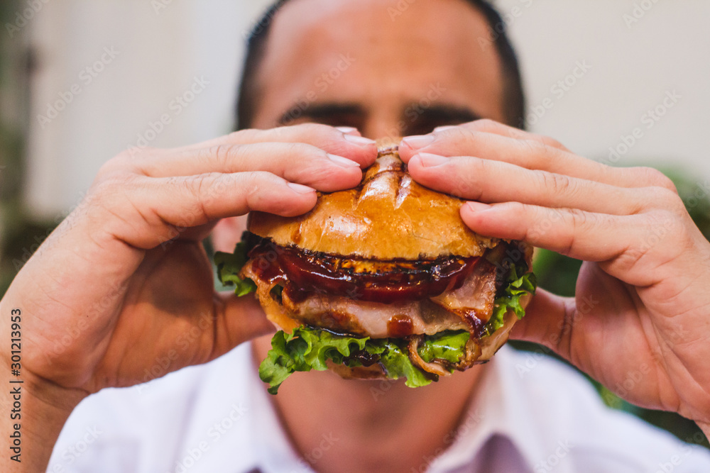young man with hamburger young man with hamburger