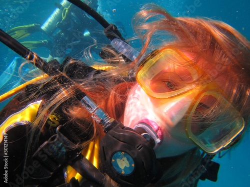  young woman in mask for diving in the sea