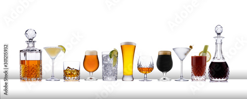 A line of aclcoholic drinks from whisky to lager, in a line, on a white bar like surface