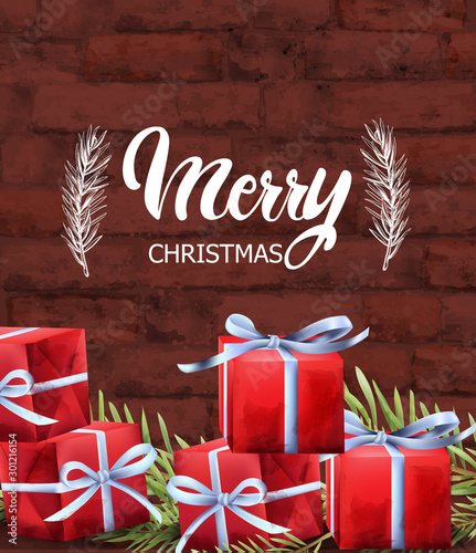 Merry Christmas red gift boxes with white ribbon. Green fir tree leaves. Bric...