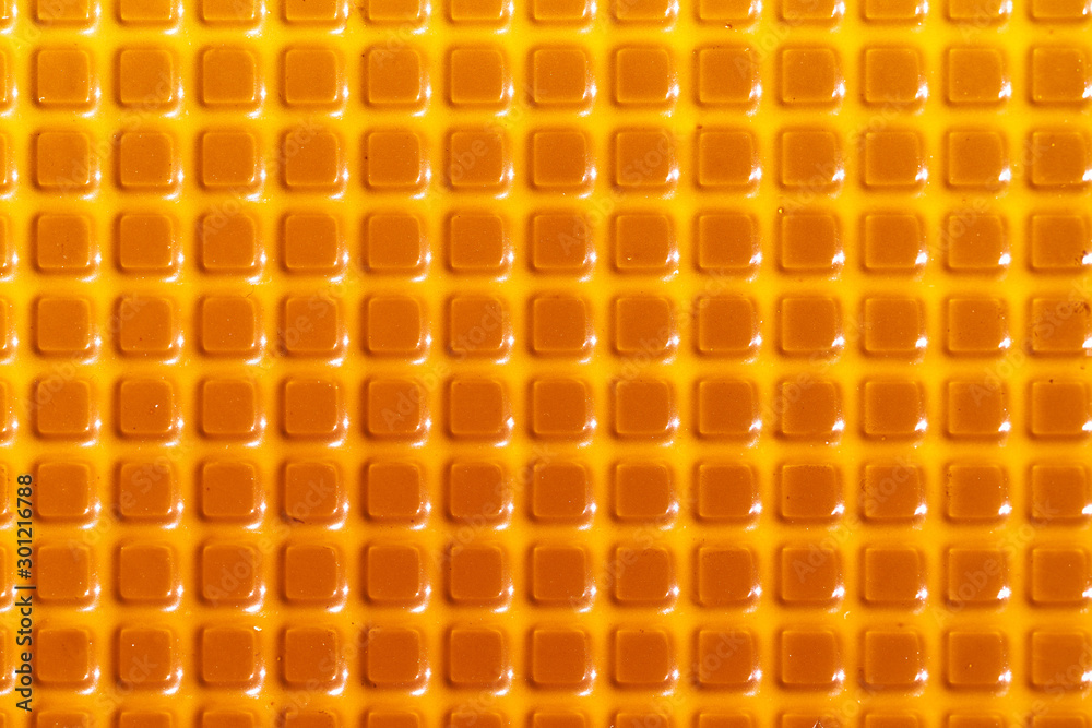 Fototapeta premium Texture with square yellow elements. Plastic candy lining