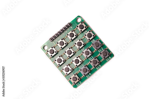 Lots of black little buttons on green PCB isolated on white background
