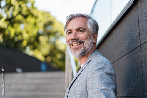 Portrait of smiling fashionable mature, businessman outdoors