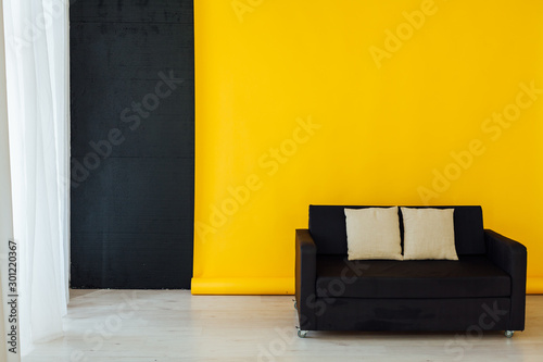 black office sofa in the yellow office interer photo