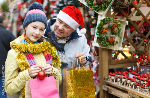 Smiling girl and father with shopping bags