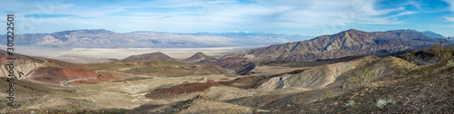 USA, California, Inyo County, Death Valley National Park. A panorama of the scenic view from Father Crowley Overlook showing CA State Route 190 highway road curving down towards Panamint Valley.