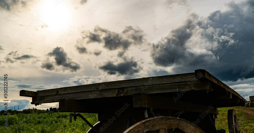 Antique wooden cart standing alone in a field, beautiful autumn landscape, hyperlapse, time lapse, heavy autumn sky Antique wooden cart standing alone in a field, beautiful autumn landscape, hyperlapse, time lapse, heavy autumn sky
