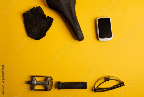 Bicycle, Cycling accessories on the yellow background. view from above.