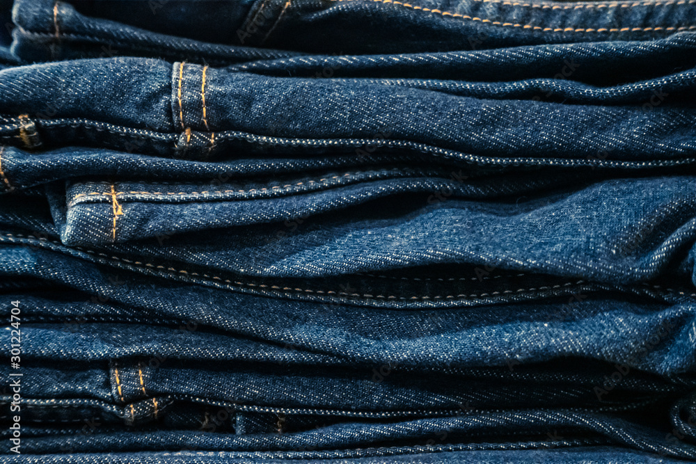 Stack of blue jeans trousers background Stack of blue jeans trousers background
