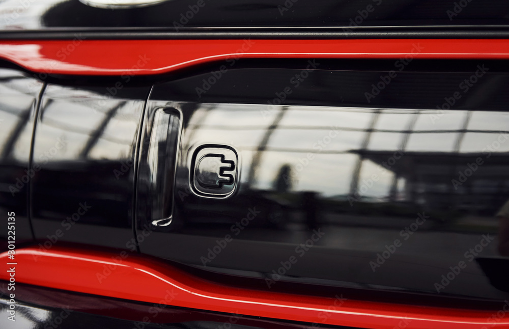 Naklejka premium Particle view of brand new modern electric car. Cropped photo