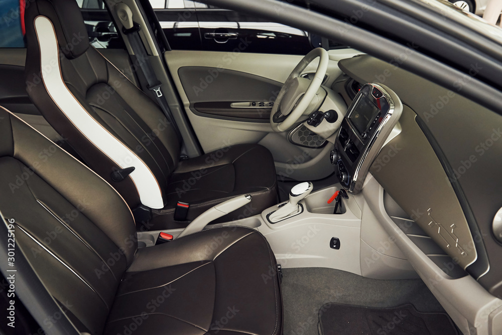 Inside of brand new modern electrical car. Particle view. Cropped photo Inside of brand new modern electrical car. Particle view. Cropped photo