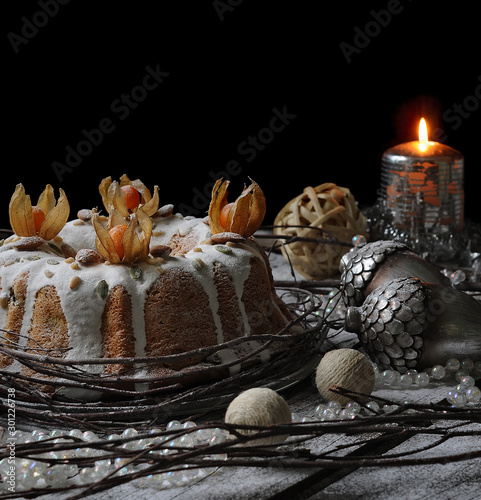 food photography of tasty christmas cake front view with winter decor on a black background close up