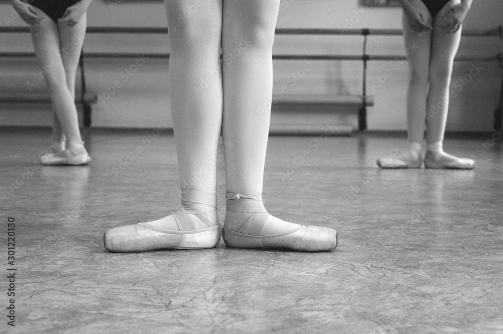 Close-up of ballerina on pointe shoes in the dance hall. Vintage photography. Close-up of a ballerina in the dance hall. Black and white photography. Stock Photo | Adobe Stock