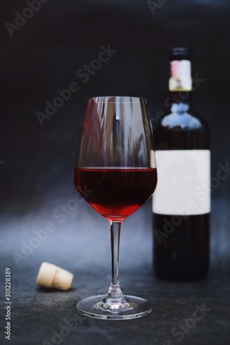 glass of wine and bottle of red wine