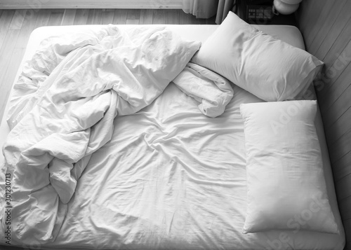 Unmade bed in bedroom. Black and white color tone. Object with copy space background.
