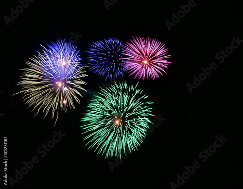 Multicolored fireworks isolated in dark background close up with the place for text
