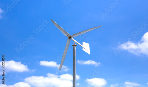 Manual wind turbine on blue sky 