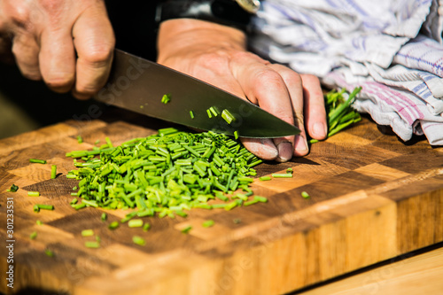 Close up hands of chef preparing food in the kitchen of a restaurant, cooking concept